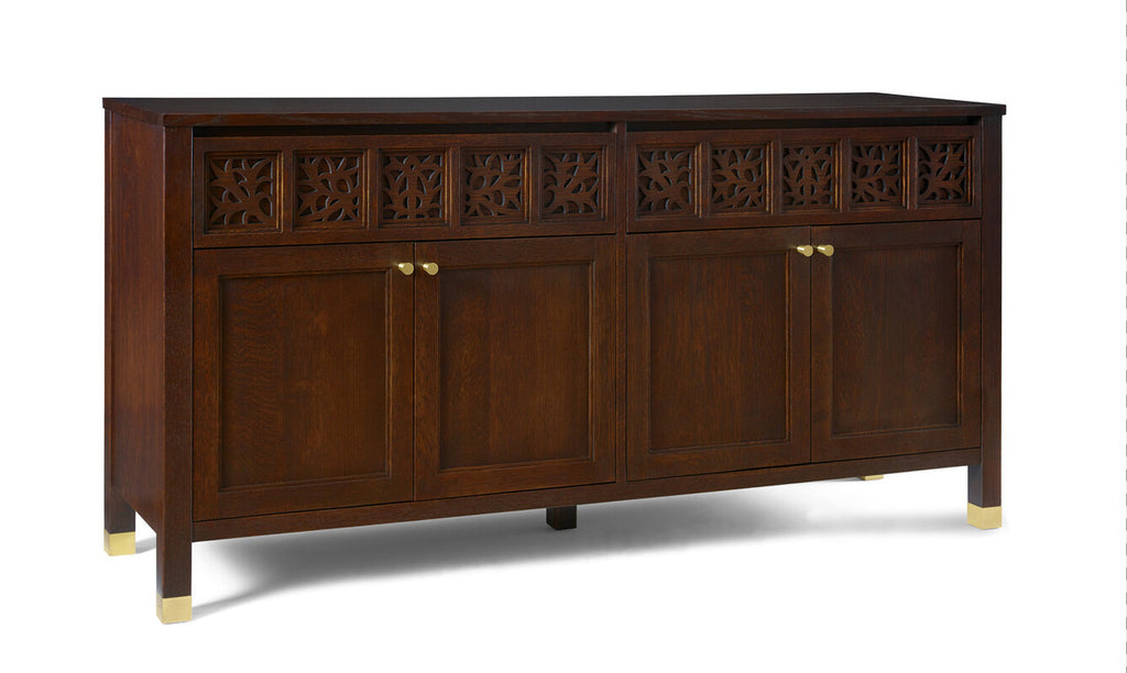 Dark wooden sideboard with decorative carvings and gold handles on a white background