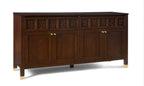 Dark wooden sideboard with decorative carvings and gold handles on a white background
