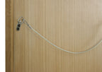 Security cable lock on a wooden door