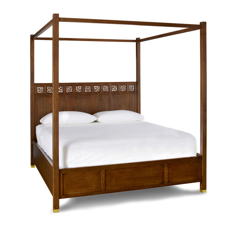 Wooden canopy bed with white bedding on a white background