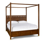 Wooden canopy bed with white bedding on a white background