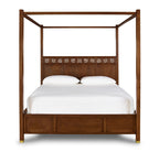 Wooden canopy bed with white bedding on a white background