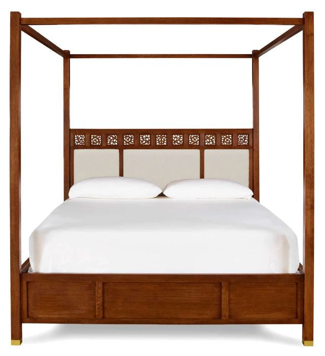 Wooden four-poster bed with white bedding on a white background