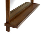 Wooden shelf below the mirror. 