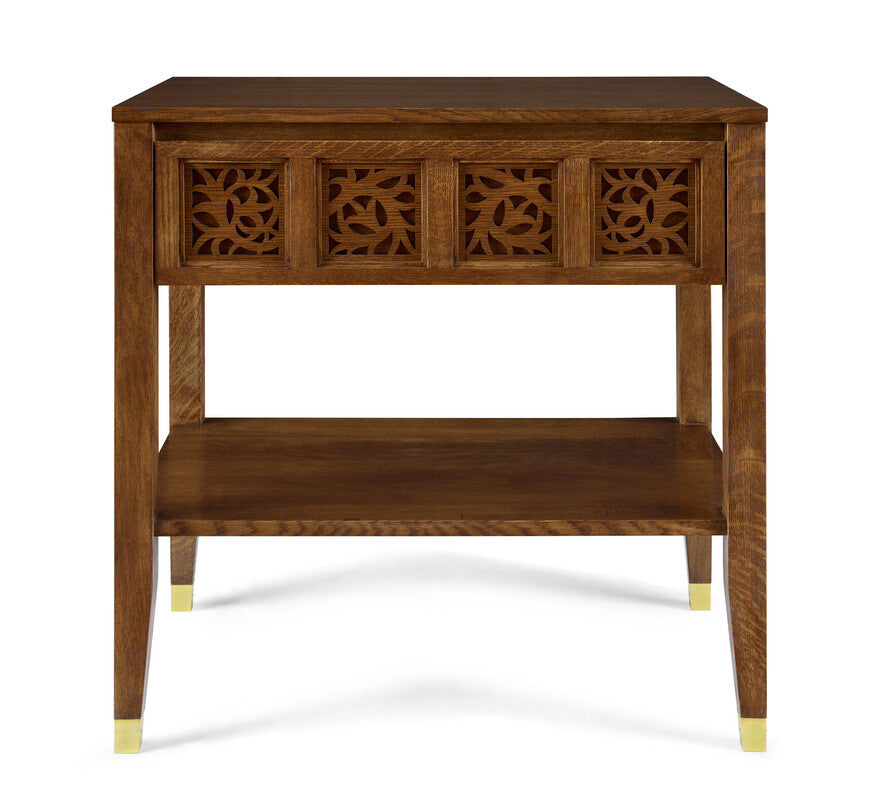 Wooden side table with decorative carvings on a white background
