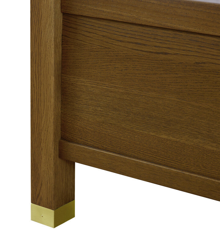 Wooden furniture leg with gold base on a white background
