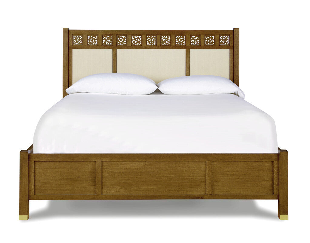 Wooden bed with decorative headboard on a white background