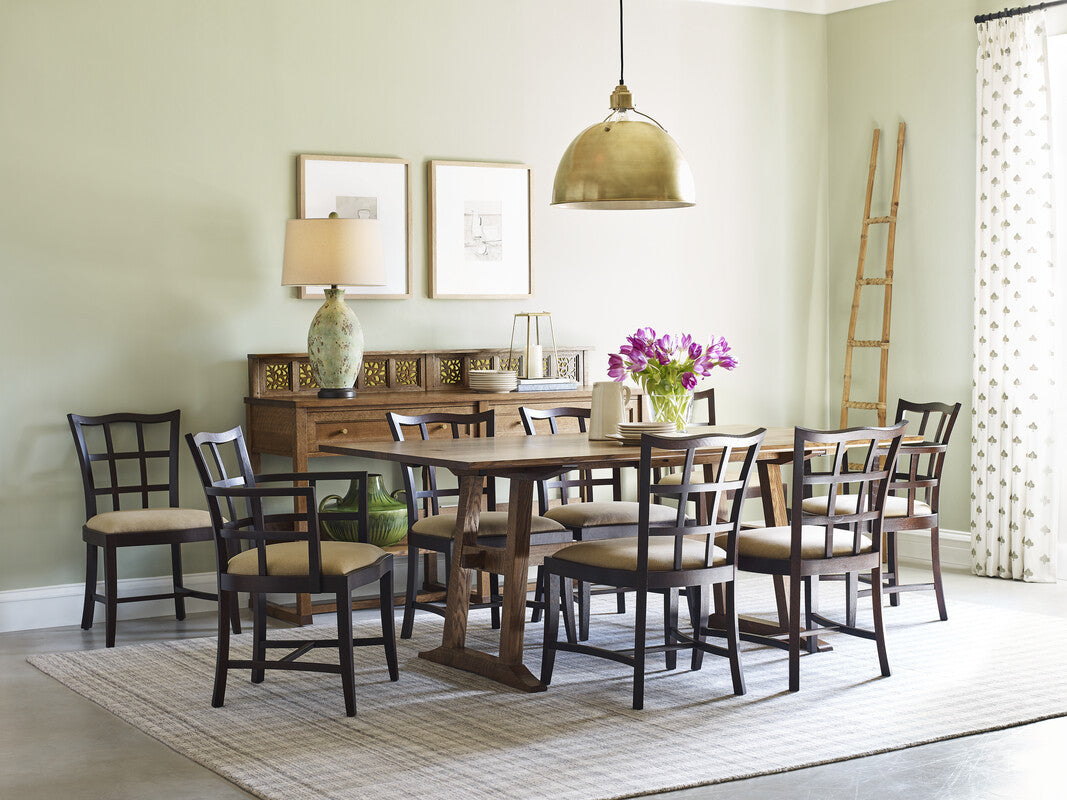 Dining room with wooden table and chairs, decorative elements, and a rug.