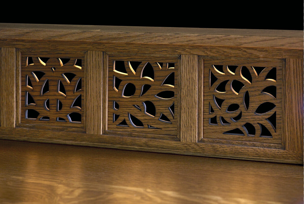 Wooden panel with intricate carvings on a dark background
