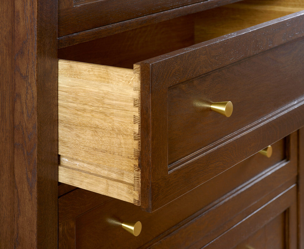 Wooden dresser with open drawer and gold handles