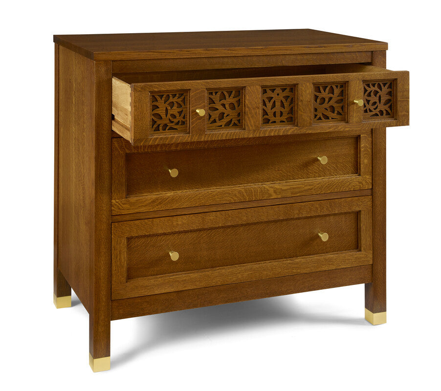 Wooden dresser with decorative carvings on a white background