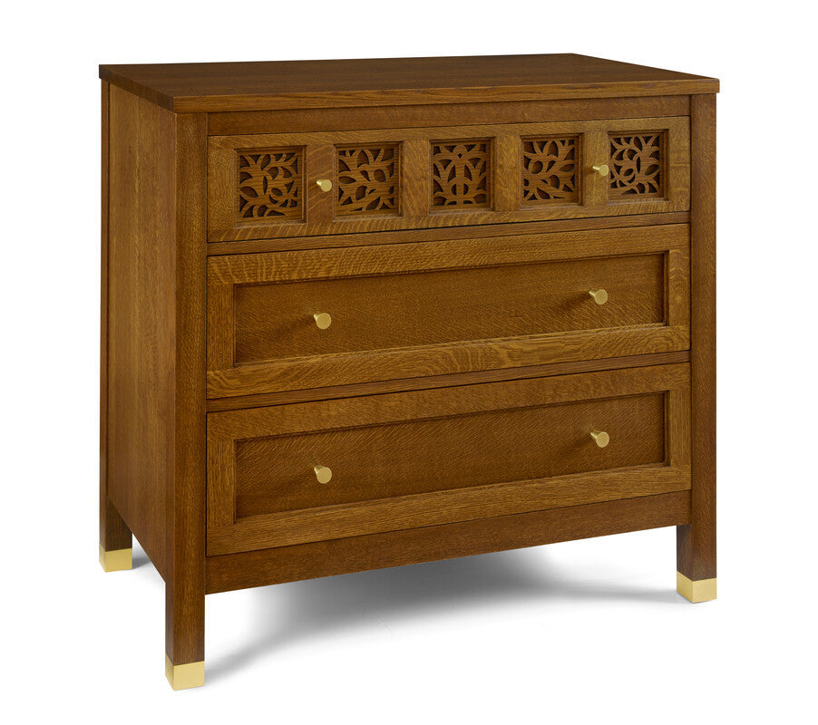 Wooden dresser with decorative carvings on a white background