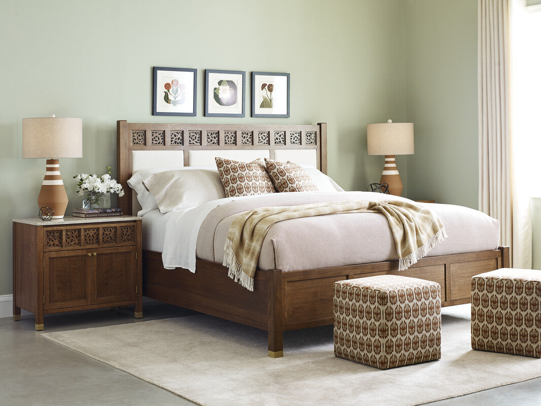 Wooden bedroom set with bed, nightstands, and lamps against a light green wall.