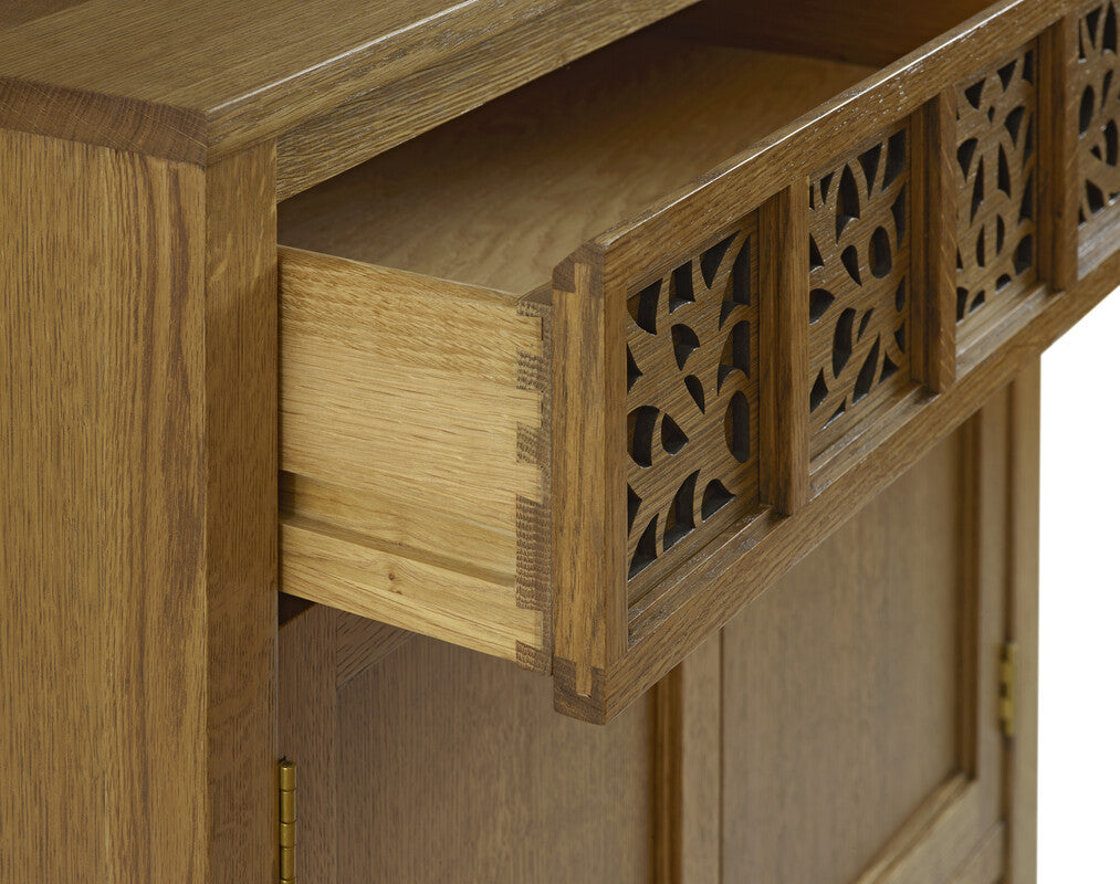 Wooden cabinet with decorative lattice design on a white background