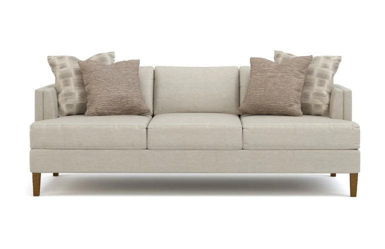 Beige sofa with patterned cushions on a white background