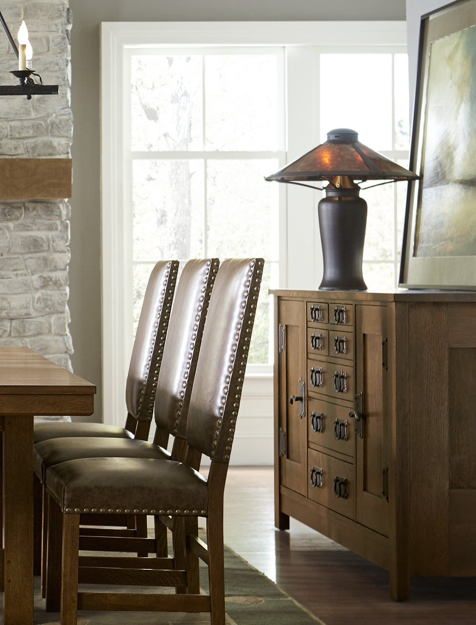 Dining room with wooden table, chairs, and sideboard.