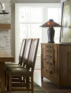 Dining room with wooden table, chairs, and sideboard.