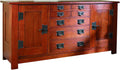 Wooden sideboard with multiple drawers and doors on a white background