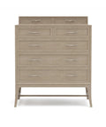 Beige dresser with multiple drawers on a white background