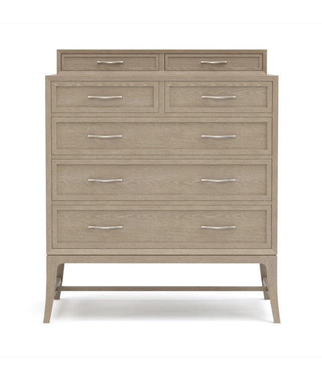 Beige dresser with multiple drawers on a white background