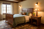 Wooden bed with beige bedding on a white background