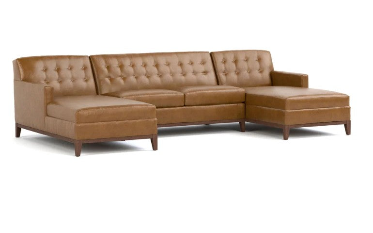A three-seater sectional sofa with a right-facing chaise lounge, upholstered in tan leather with button tufting on the backrests, supported by dark wood legs, shown against a plain white background.