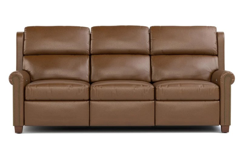 A three-seat brown leather sofa with deep channel tufting on the backrest and seat, rolled nailhead trim on the arms, and dark wood legs, shown against a plain white background.