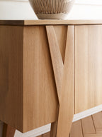 Close-up of a wooden cabinet with a vase on top