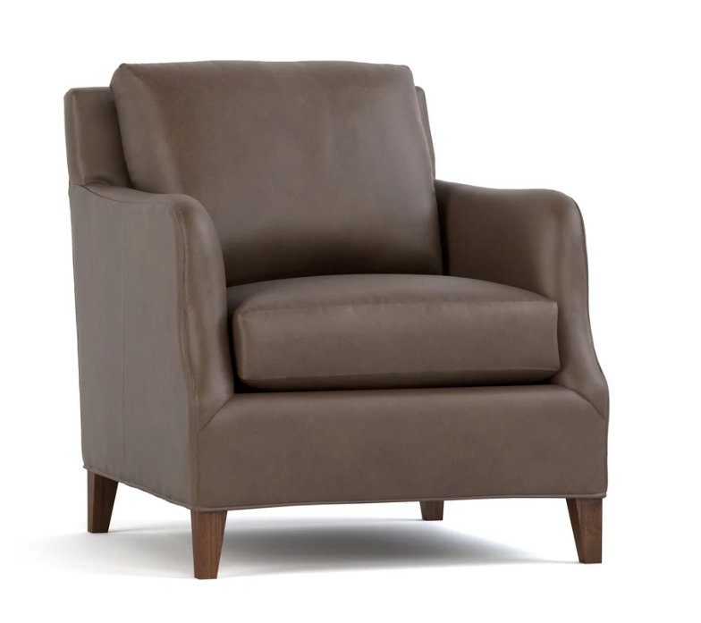 A brown upholstered armchair with a high back, wide armrests, and tapered dark wood legs, shown on a plain white background.