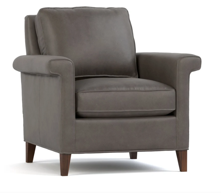 A dark gray upholstered armchair with rolled arms, a high back, and dark wood legs, shown on a plain white background.
