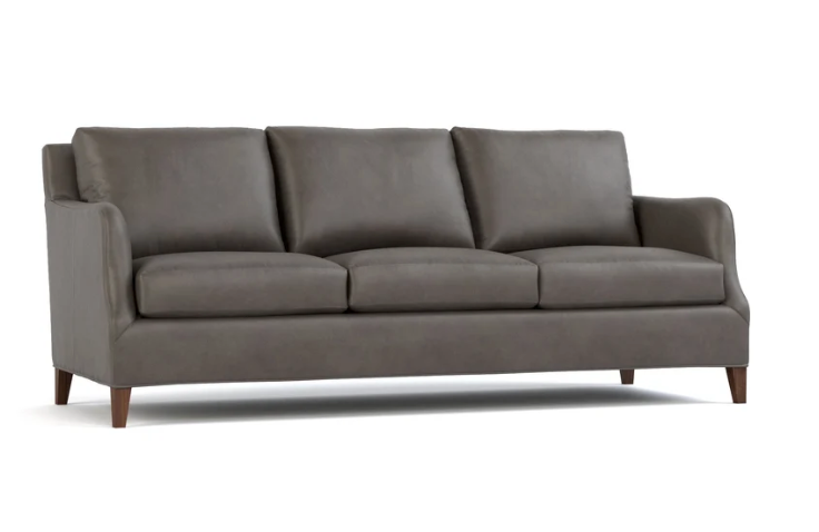 A three-seat sofa upholstered in dark gray leather with dark brown wooden legs, shown from a front angle on a white background.