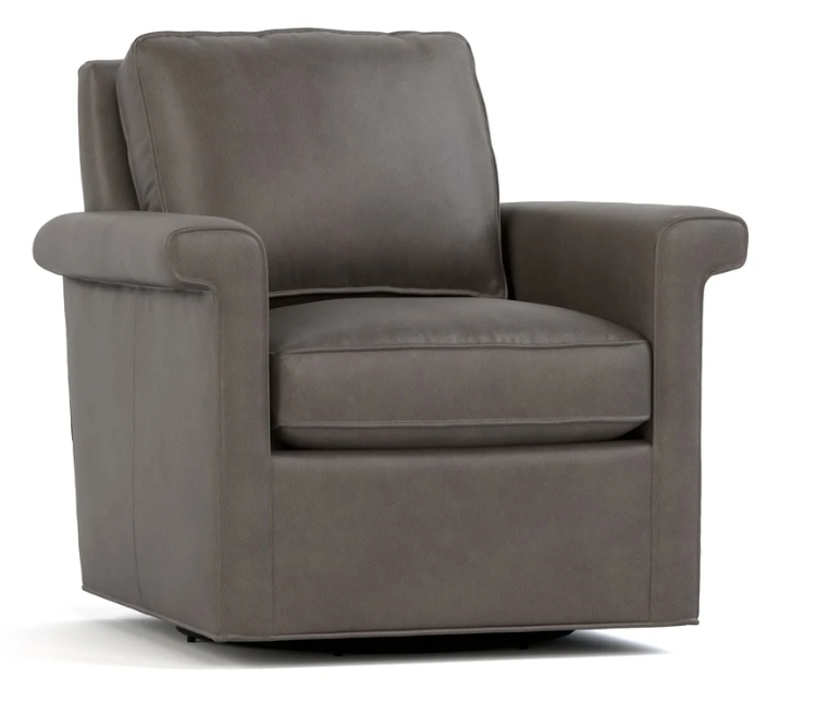 A dark gray upholstered armchair with a high back, wide armrests, and a cushioned seat, shown on a plain white background.