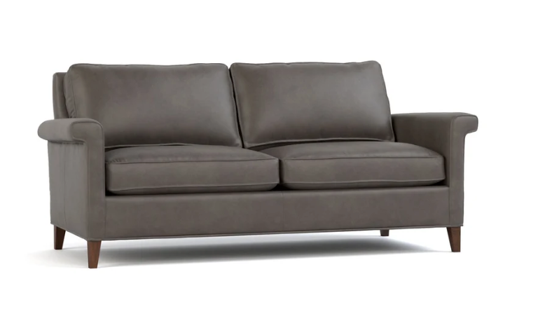 A two-seater loveseat sofa upholstered in dark gray fabric, featuring rolled arms, two back cushions, two seat cushions, and dark wooden legs, shown against a plain white background.