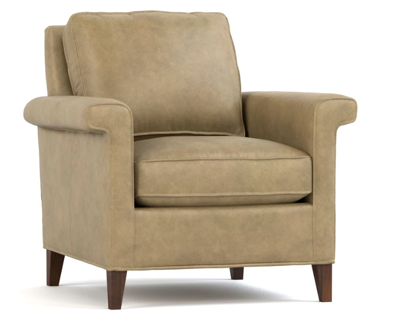 A classic armchair upholstered in a textured tan fabric with dark brown wooden legs, shown against a plain white background.