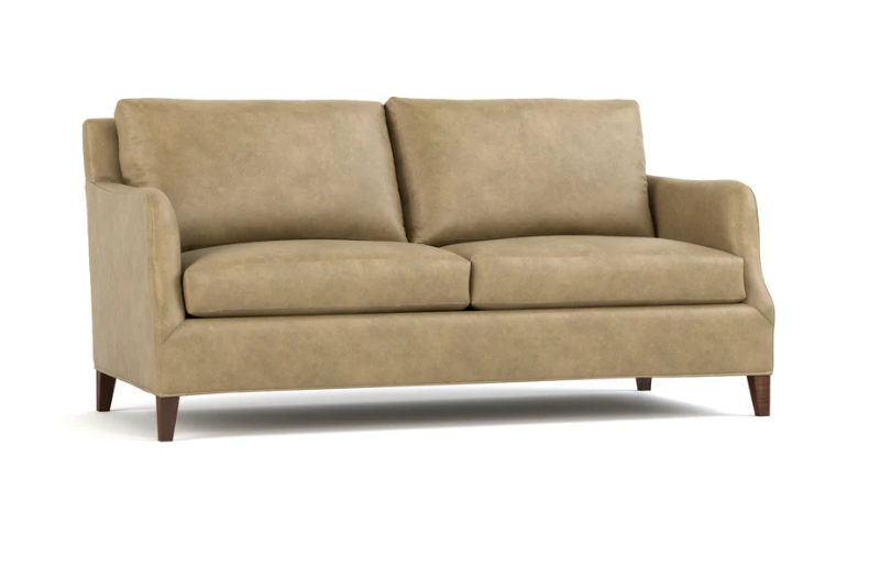 A two-seater loveseat sofa upholstered in a textured tan fabric, featuring dark brown wooden legs, shown against a plain white background.