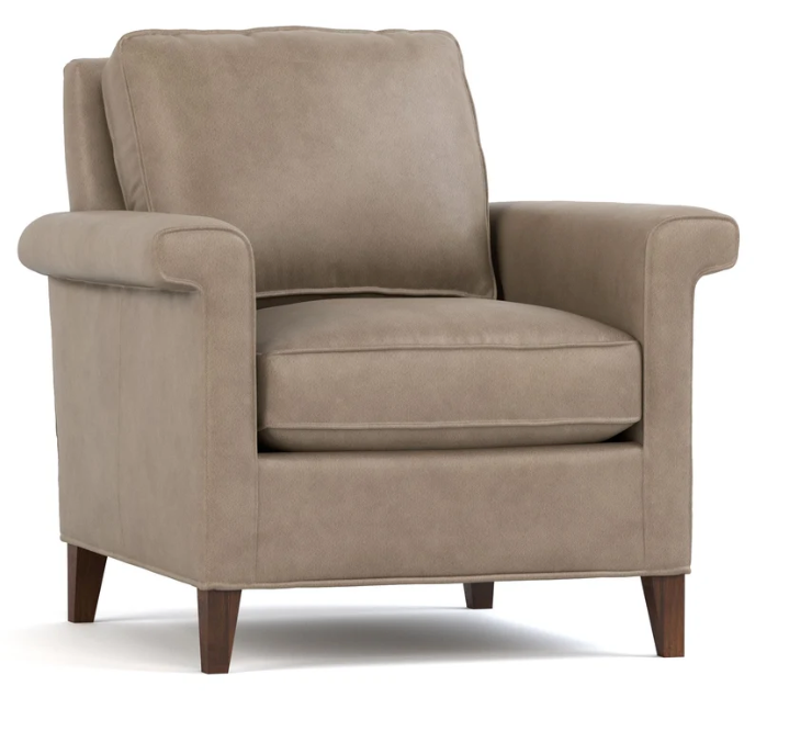 A classic upholstered armchair in a warm taupe fabric with dark brown wooden legs, shown from a three-quarter angle on a white background.