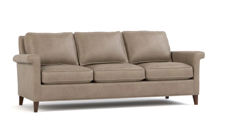A three-seat upholstered sofa in a taupe-brown fabric, featuring dark brown wooden legs, shown against a plain white background.