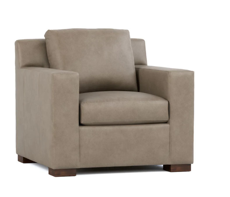 A modern armchair upholstered in a textured taupe fabric with dark brown wooden feet, shown from a three-quarter angle on a white background.
