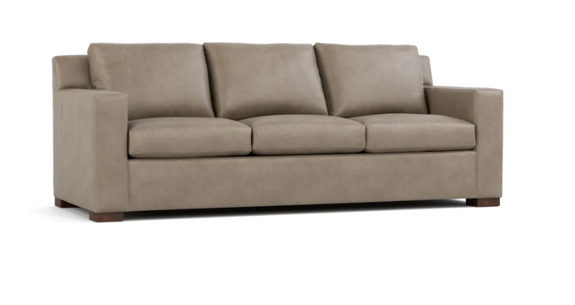 A three-seat upholstered sofa in a taupe-brown fabric, shown from a three-quarter angle against a plain white background.