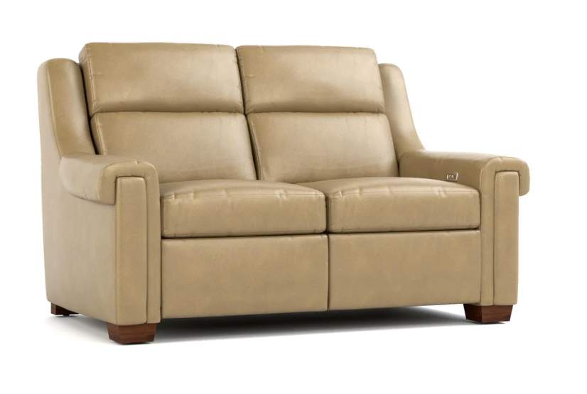 A beige leather reclining loveseat sofa with dark brown wooden feet, shown from a three-quarter angle on a white background.