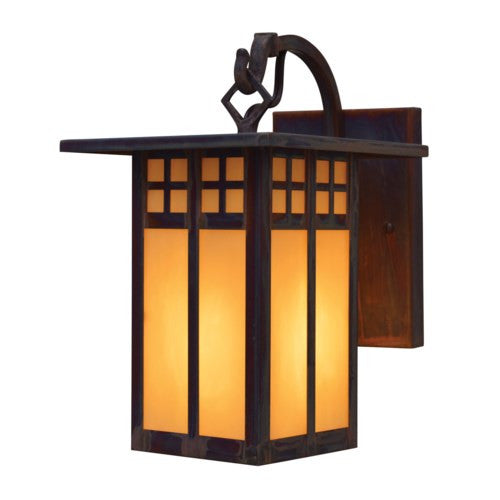 Decorative wall sconce with glass panels on a white background