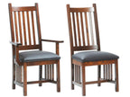 Two wooden chairs with gray cushions on a white background