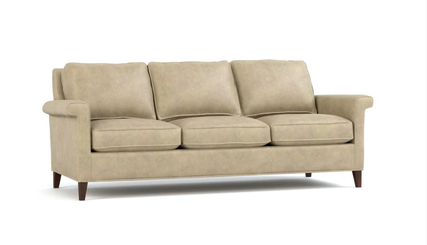 A three-seat upholstered sofa in a light beige fabric, featuring dark brown wooden legs, shown against a plain white background.