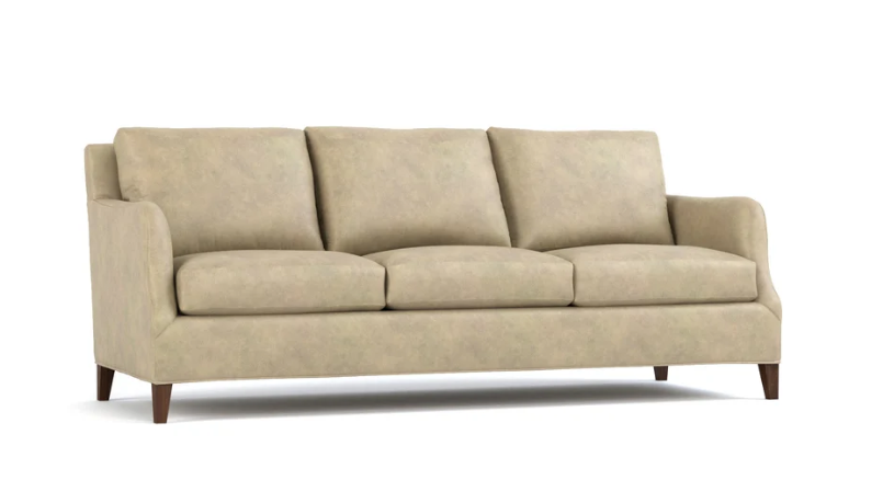 A three-seat upholstered sofa in a light beige fabric with dark brown wooden legs, shown against a plain white background.