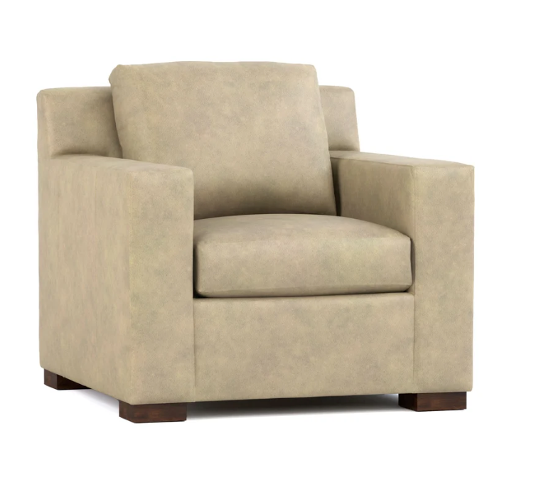 A beige upholstered armchair with a high back, square arms, and dark wooden feet, shown against a plain white background.