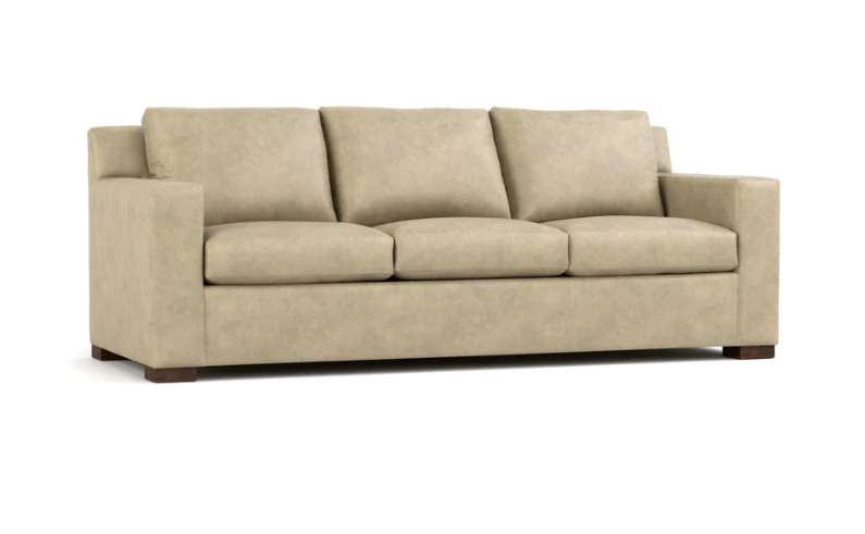 A three-seat upholstered sofa in a light beige fabric, featuring three back cushions and three seat cushions, shown against a plain white background.