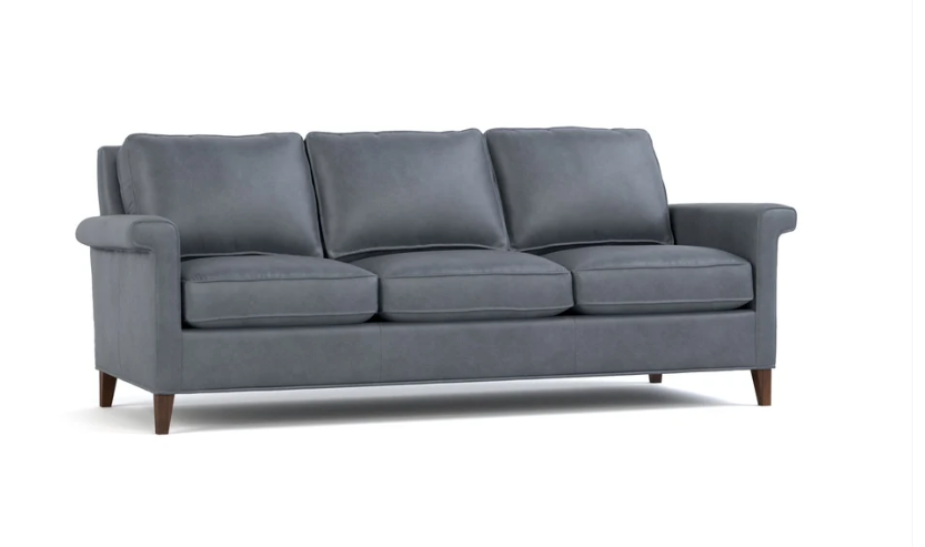 A three-seat gray upholstered sofa with dark brown wooden legs, shown from a three-quarter angle on a white background.