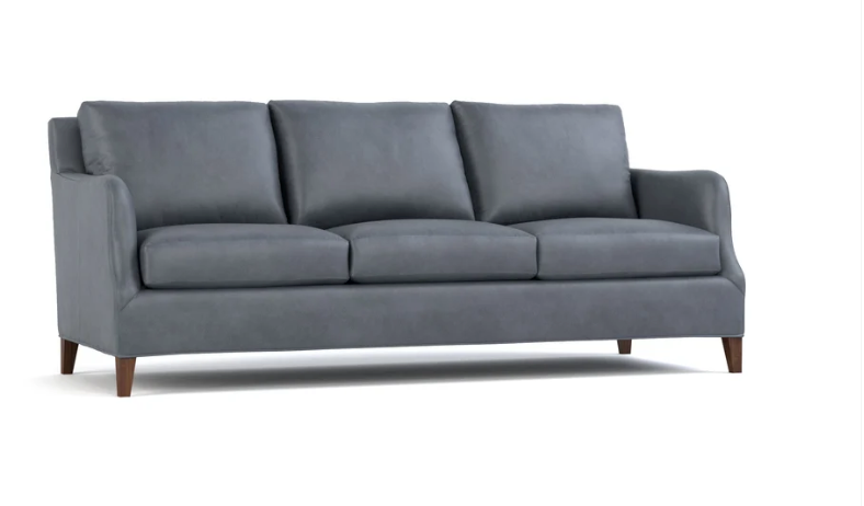 A three-seat gray upholstered sofa with dark brown wooden legs, shown from a three-quarter angle on a white background.