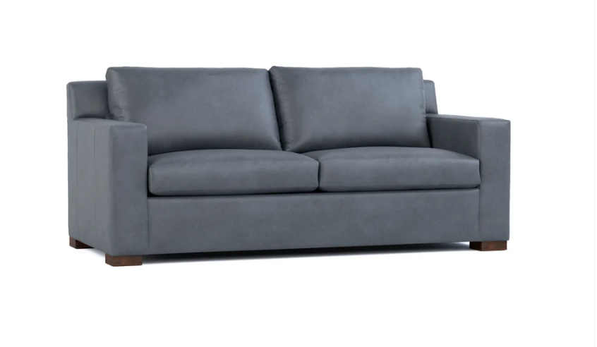 A modern two-seater sofa upholstered in a textured gray fabric, featuring square arms, two back cushions, and dark brown wooden legs, shown against a plain white background.